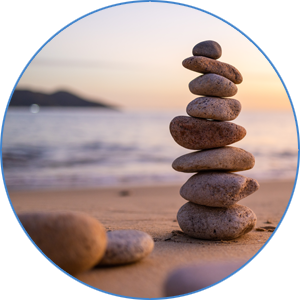 Balanced stones on a beach symbolizing Advanced Cosmetic & Family Dentistry’s holistic approach to oral